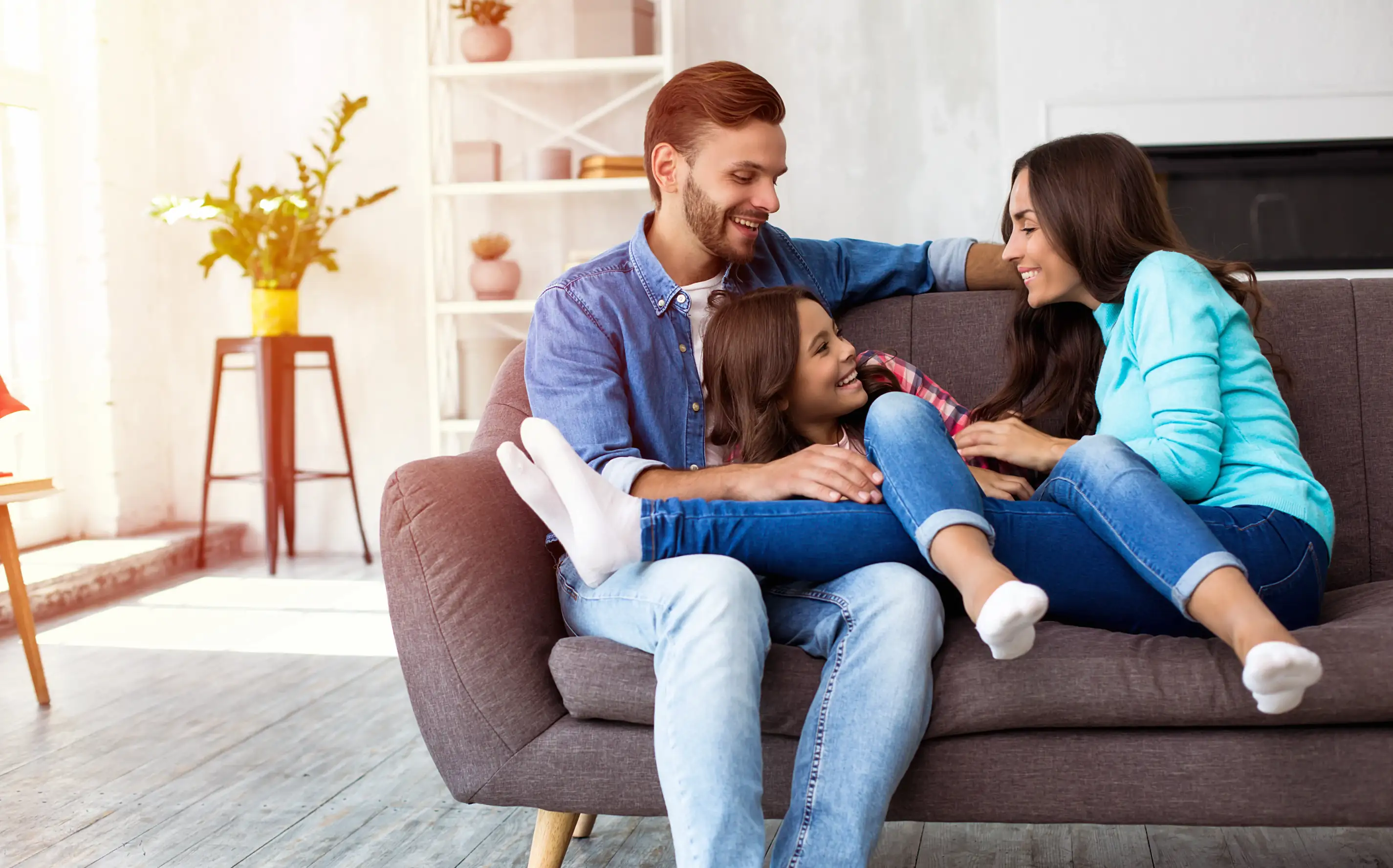 three family members sitting on a couch together